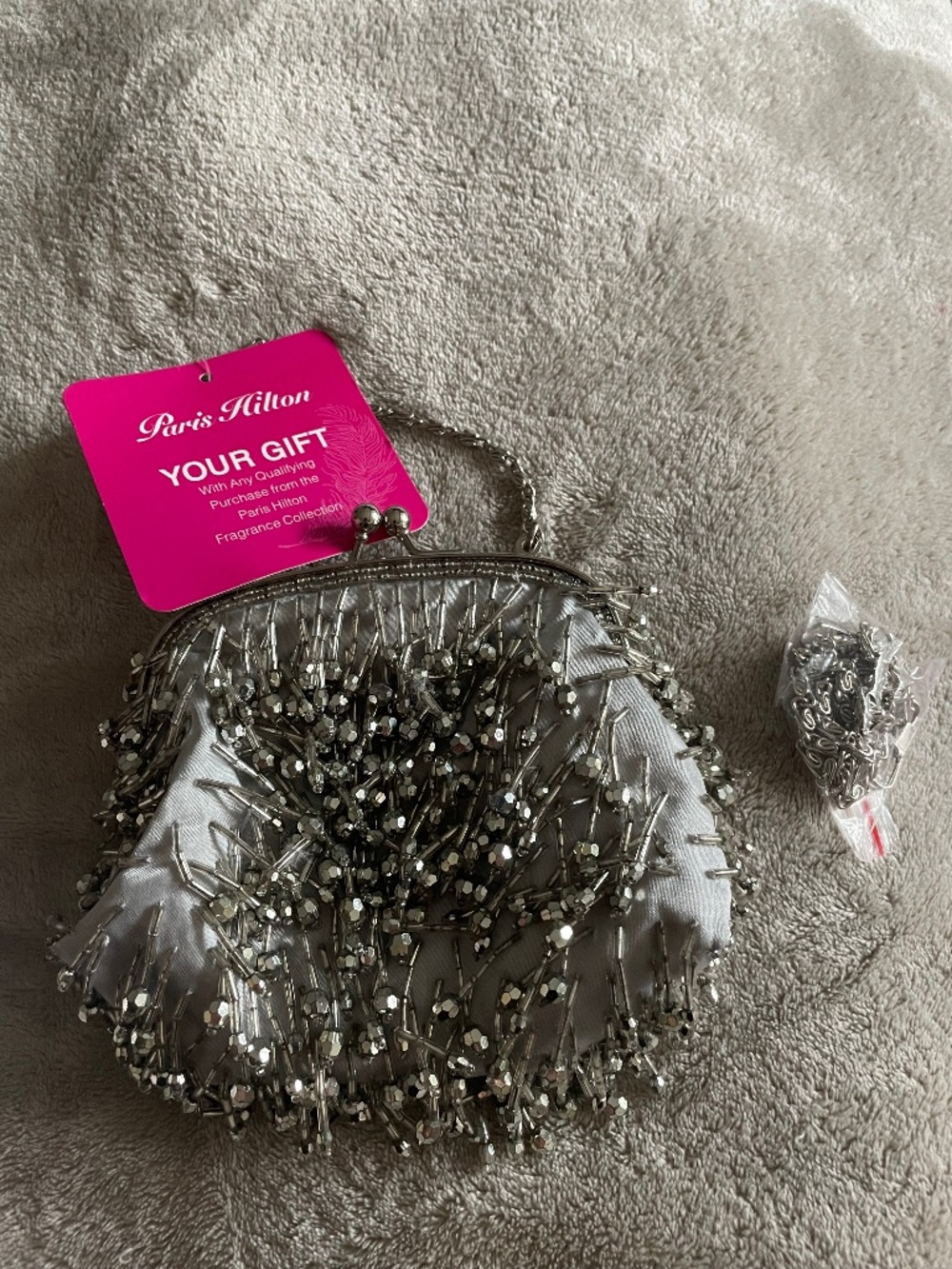 New Paris Hilton silver beaded evening clutch .